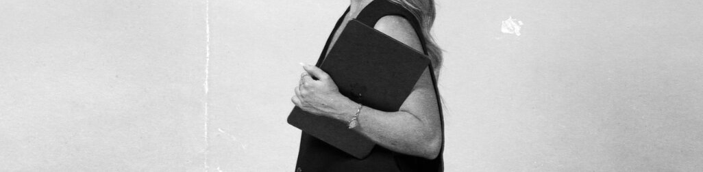 Practitioner carrying a laptop ahead of an online session